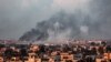 Gambar yang diambil dari Rafah menunjukkan asap mengepul di atas kota Khan Yunis di Jalur Gaza selatan selama pemboman Israel hari Minggu, 18 Februari 2024.