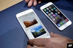 FILE - The iPhone 6 plus, left, and iPhone 6 are displayed, in Cupertino, Calif.