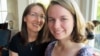 Sheila Dougherty, left, encouraged daughter Annemarie to become one of the first female altar servers in her Catholic parish in Arlington, Virginia. With them is the family dog, Maple. (C. Guensburg/VOA News) 