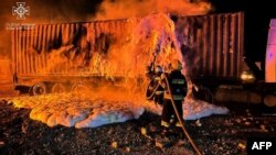 FILE - Firefighters work to extinguish a fire on the port infrastructure on the Danube River, in the Odesa region, on Oct. 6, 2023, amid the Russian invasion in Ukraine. (Ukrainian Emergency Service via AFP)
