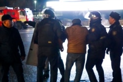 FILE - Police detain a protester during clashes in the center of Almaty, Kazakhstan, Jan. 5, 2022.