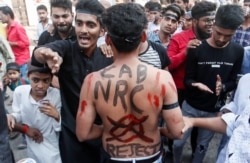 A man with a slogan painted on his back is seen during a protest against a new citizenship law, on the outskirts of Mumbai, India, December 18, 2019. REUTERS/Francis Mascarenhas