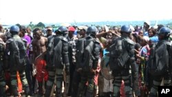 FILE - Displaced residents fleeing sectarian violence were cordoned off by military at the airport in Bangui, Central African Republic. 