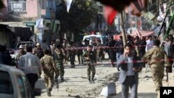 Security forces inspect the site of a suicide attack outside a Shiite mosque in Kabul, Afghanistan, Sept. 29, 2017.