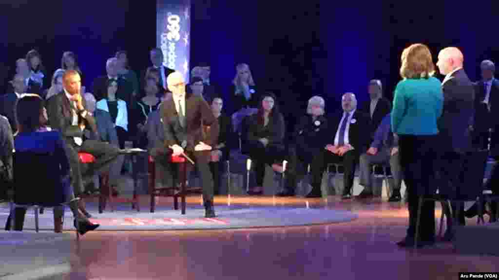 Former U.S. Rep. Gabby Giffords of Arizona, in green jacket, and her husband, Mark Kelly, left, participate in President Barack Obama's televised town hall at George Mason University in Fairfax, Va., Jan. 7, 2016. Gabby Giffords was shot during a campaign event in Arizona in 2011.