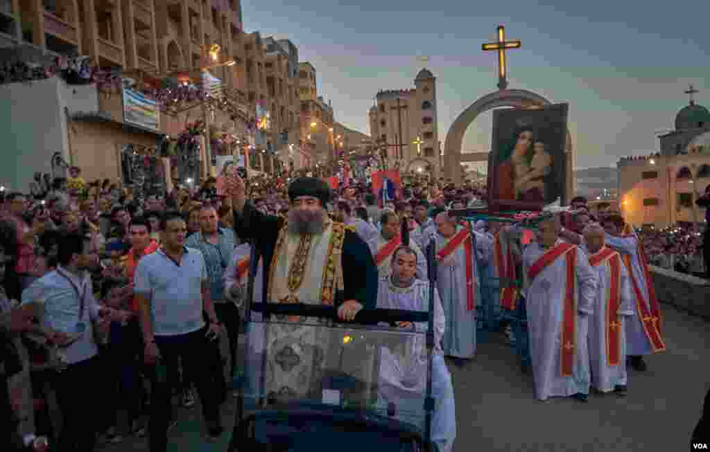 Bishop Uannas, the head of the Virgin Mary Monastery in Assiut is cheering pilgrims and spreading blessings as a part of his daily procession during the 15 days of celebration in August. Sunday, August 18, 2019.