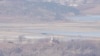 North Korea's town Kaepoong behind a military guard post, bottom, is seen from the unification observatory in Paju, South Korea, Jan. 16, 2024. North Korean leader Kim Jong Un said his country would no longer pursue reconciliation with South Korea.