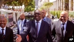 South Africa Finance Minister Nhlanhla Nene, center, arrives at parliament to deliver the annual South Africa budget speech to Parliament in Cape Town, South Africa, Wednesday, Feb. 25, 2015.