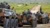 China's army soldiers sit on their tanks as they attend the opening of military exercise in Kampong Speu province, Cambodia, March 17, 2018. Hundreds of soldiers began a 15-day joint military exercise this week.