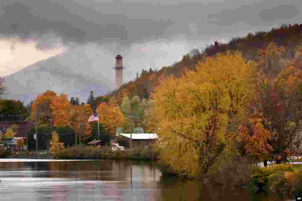 Fall foliage adds color to a rainy day along the Androscoggin River in Berlin, New Hampshire. 