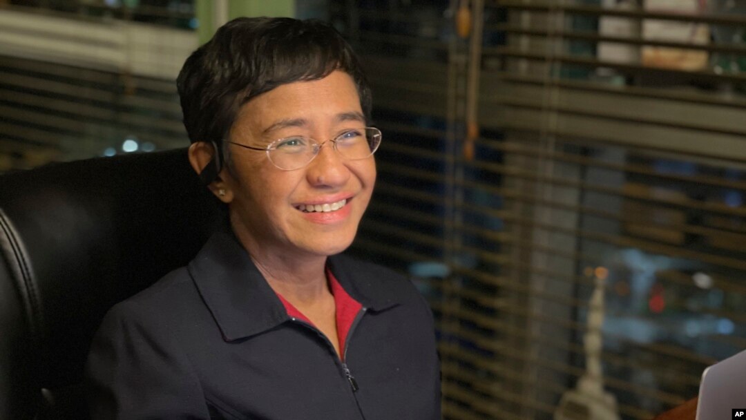 FILE - In this photo provided by the Rappler, Rappler CEO and Executive Editor Maria Ressa reacts after hearing she won the Nobel Peace Prize, inside her home in Taguig, Metro Manila, Philippines, Oct. 8, 2021.