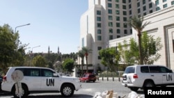 United Nations vehicles are parked in front of the Four Seasons hotel, where a team of experts from the Organization for the Prohibition of Chemical Weapons (OPCW) are staying, in downtown Damascus, Oct. 22, 2013. 