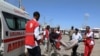 Civilians carry the body of a man killed in a car bomb explosion at a checkpoint in Mogadishu, Somalia, Dec. 28, 2019.