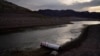 A buoy once used to warn of a submerged rock rests on the ground along the waterline near a closed boat ramp on Lake Mead at the Lake Mead National Recreation Area, Aug. 13, 2021, near Boulder City, Nev.