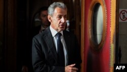 French former President Nicolas Sarkozy leaves after the verdict in his appeal trial in Paris on Feb. 14, 2024.