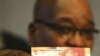 South Africa's President Jacob Zuma holds up a banknote bearing the face of former president Nelson Mandela in Pretoria February 11, 2012.
