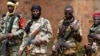 Seleka fighters warily eye a photographer at their base in Bambari, Central African Republic, on May 31, 2014. 