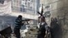 Free Syrian Army fighters fire at enemy positions during heavy clashes with government forces in the Salaheddine district of Aleppo, December 29. (AP)