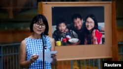 Hua Qu speaks to people attending a vigil for Xiyue Wang at Princeton University in Princeton, N.J. Sept. 15, 2017.