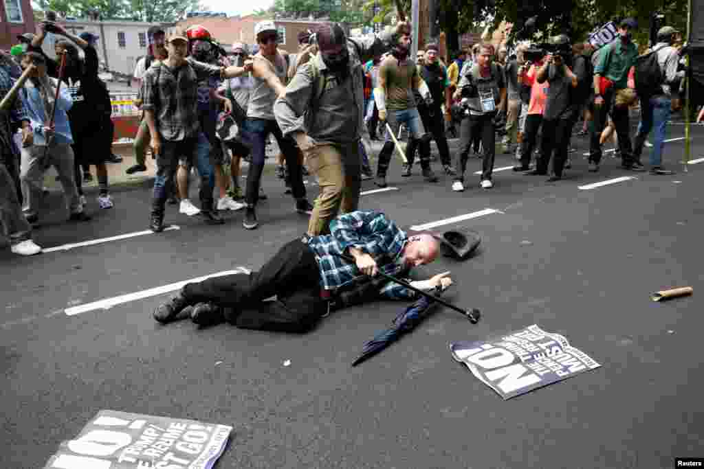 A man is down during a clash between members of white nationalist protesters and a group of counterprotesters in Charlottesville, Va., Aug. 12, 2017.