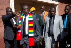 Zimbabwean President Emmerson Mnangagwa leaves the polling station after casting his vote for the presidential elections at the Sherwood Primary School in Kwekwe, Zimbabwe, July 30, 2018.