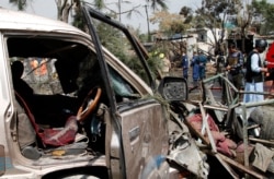Afghan security personnel work at the site of an explosion in Kabul, Sept. 9, 2020.