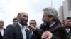 FILE - Journalists Can Dundar, right, and Erdem Gul, Ankara bureau chief of Cumhuriyet newspaper, speak before the start of their trial, hours before the attack on Can Dundar outside city's main courthouse in Istanbul, May 6, 2016. 
