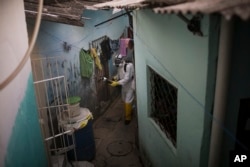 A municipal worker sprays insecticide to combat the Aedes aegypti mosquitoes that transmits the Zika virus, at the Imbiribeira neighborhood in Recife, Pernambuco state, Brazil, Jan. 26, 2016.