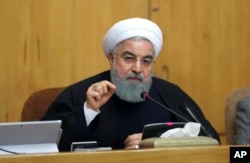 In this photo released by official website of the office of the Iranian Presidency, President Hassan Rouhani speaks in a cabinet meeting in Tehran. Dec. 31, 2017.