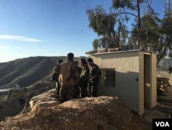 Iraqi Kurdish Peshmerga soldiers huddle around Maj. Gen. Sirwan Barzani in Makhmour, Iraq. Makhmour is expected to serve as one of the staging points for Iraqi and Peshmerga forces in the advance against the Islamic State-controlled city of Mosul, March 8, 2016.