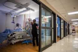 A registered nurse attends a patient with Covid-19 at the Cardiovascular Intensive Care Unit at Providence Cedars-Sinai Tarzana Medical Center in Tarzana, California on September 2, 2021. (Photo by Apu GOMES / AFP)