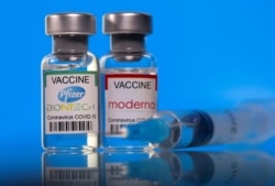 FILE PHOTO: Vials with Pfizer-BioNTech and Moderna coronavirus disease (COVID-19) vaccine