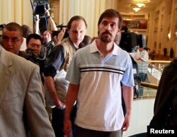 FILE - U.S. journalist James Foley, right, arrives after being released by the Libyan government, in Tripoli, in this picture taken May 18, 2011. Foley was kidnapped on Nov. 22, 2012, in northern Syria.