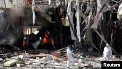 Forensic experts investigate the scene at the community hall where Saudi-led warplanes struck a funeral in Sanaa, the capital of Yemen, October 9, 2016. 