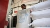 A Palestinian worker empties sacks of flour donated by the World Food Programme at a bakery in Gaza City on April 14, 2024, amid the ongoing conflict between Israel and the militant group Hamas.