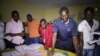 Electoral officials sort out ballot papers at the end of presidential elections in Conakry, Guinea, Oct. 11, 2015. 
