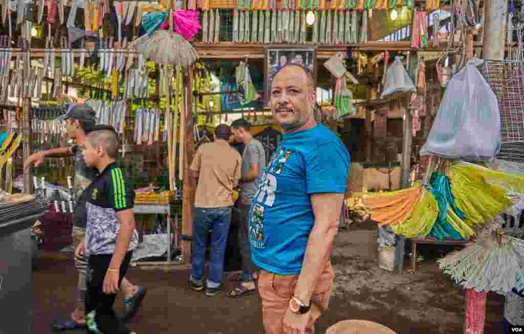 Ashour Al-Sanan, who have been trading in butchery-tools for 25 years in Old Cairo, says, "Only the prices of meat dropped down, but the prices of everything else raised, I think that is why the turnout this year is not like past years." (H. Elrasam/VOA)