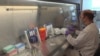 A technician inspects vials of coronavirus disease (COVID-19) vaccine candidate BNT162b2 at a Pfizer manufacturing site in manufacturing site in St. Louis, Missouri, U.S. in an undated photograph. (Pfizer/Handout via REUTERS)