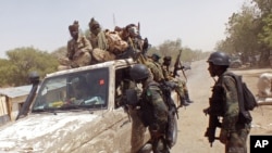 FILE - Cameroon soldiers check a truck on the border between Cameroon and Nigeria, Feb. 19, 2015. Attacks in a Cameroon village along the border from June 25 to 27, 2022, left at least 30 people dead.