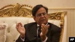 FILE - Pakistani lawyer Saiful Malook who is defending a Christian woman facing the blasphemy charges, talks to the Associated Press in Lahore, Pakistan, Feb. 28, 2018.
