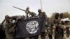 FILE PHOTO - Nigerian soldiers hold up a Boko Haram flag that they had seized in the recently retaken town of Damasak, Nigeria.