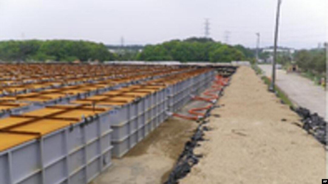 Temporary storage tanks for low and middle level radioactive water from Tokyo Electric Power (TEPCO) Co.'s Fukushima Daiichi Nuclear Power Station's No.1, No.2, No.3 and No.4 reactors are seen at the grounds of the plant in Fukushima prefecture, June 5, 2