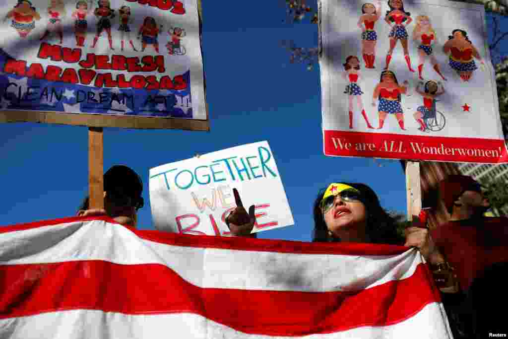 People hold an American flag during the second annual Women's March in Los Angeles, California, Jan. 20, 2018.