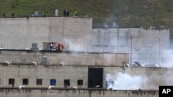 FILE - Tear gas rises from parts of the Turi prison where an inmate riot had broken out in Cuenca, Ecuador, Feb. 23, 2021. Inmates at Turi are holding more than 50 people hostage, the country's interior minister said Aug. 31, 2023, in a protest over prisoner transfers.