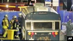 Police officers investigate the crime scene after a gunman fired shots at US soldiers on the bus outside Frankfurt airport, Germany, killing two airmen and wounding two before being taken into custody, March 2, 2011