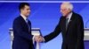 Democratic presidential candidates former South Bend Mayor Pete Buttigieg and Sen. Bernie Sanders, I-Vt., shake hands on stage Friday, Feb. 7, 2020, before the start of a Democratic presidential primary debate hosted by ABC News, Apple News, and…