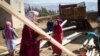 Families take the equipment back to their homes, which can collapse under the weight of snow in a refugee camp in Lebanon's Bekaa region. Concerns are growing as winter approaches and more Syrian refugees in Lebanon are driven by debt into makeshift shelters.