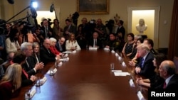 U.S. President Donald Trump, third from right, listens to House Majority Leader Kevin McCarthy, third from left, speak during a "California Sanctuary State Roundtable" at the White House in Washington, May 16, 2018.