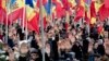 FILE - People raise their hands during an anti-government protest in Chisinau, Moldova, Jan. 24, 2016. The election of a pro-Russian president in the impoverished former Sovet republic is widely seen as a vote against the pro-Europe policies of previous Moldovan leaders.