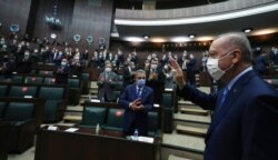 Turkey's President Recep Tayyip Erdogan arrives to address the lawmakers of his ruling party at the parliament, in Ankara, Turkey, Nov. 11, 2020.